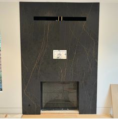 a black marble fireplace surround in a living room