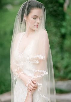 a woman in a wedding dress with a veil on her head