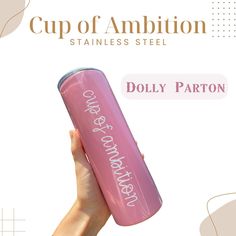 a person holding up a pink tumbler with the words cup of ampition on it