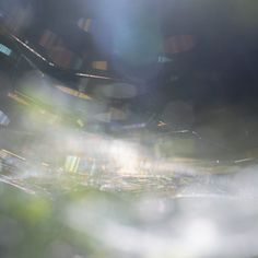 blurry photograph of an abstract cityscape with trees and buildings in the background