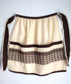 a white and brown skirt hanging on a wall