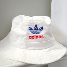 Step Out In This Vintage Style Adidas Bucket Hat. One Size Fits Most. New Without Tags Adidas Casual Adjustable Bucket Hat, Adidas Adjustable Casual Bucket Hat, Adjustable Adidas Cotton Hat, Adidas Cotton Hat With Curved Brim, Adidas Cotton Hats With Curved Brim, White Cotton Bucket Hat One Size, Adidas Cotton Summer Hats, Adidas Hats For Summer Streetwear, Adidas Cotton Hats For Summer