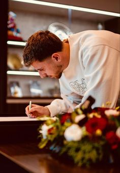 a man writing on a piece of paper