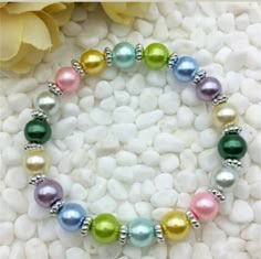 Pink, Blue, Green, Yellow, Purple, White And Silver Beaded Stretch Bracelet. Stretch Bracelets Diy, Stretch Beaded Bracelets Diy, Homemade Bracelets, Diy Jewelry Rings, Fun Bracelet, Kids Bracelets, Beads Bracelet Design, Bracelet Diy, Handmade Jewelry Diy