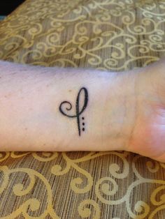 a person's wrist with a small tattoo on it