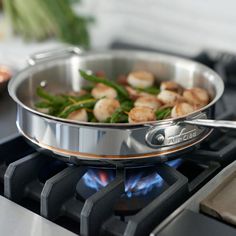 a skillet with food cooking on top of it next to a stove burner