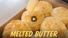 a box filled with lots of biscuits covered in cheese