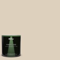 a can of behr marquee paint on a green background