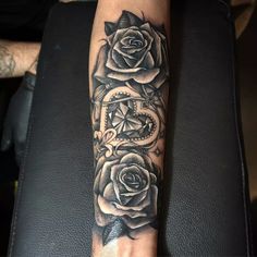 a woman's arm with roses on it and the word love written in cursive writing