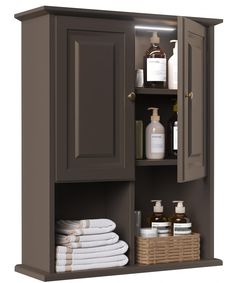 an open cabinet with towels and lotion in it