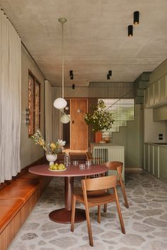 a table and chairs in a small room