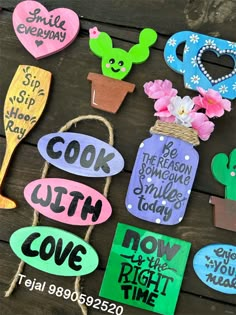 various handmade signs and magnets on a wooden table