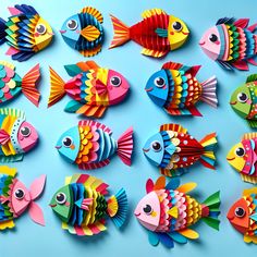 colorful paper fish are arranged on a blue surface