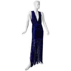 Tom Ford deco inspired hand beaded evening dress. Boasts rich beautiful cobalt blue bugle beads all hand sewn atop black silk organza extending down to skirt featuring open work fringe to showcasing lots of leg. Dress is 1 piece with additional over top. The color is a very rich saturated cobalt blue so, in lighting, the beads twinkle, sparkle and shimmer. In addition, the striking deco style mimics that of 20’s expensive heavily beaded dresses. A Tom Ford treasure with tremendous entrance appea Blue Fringe Dress For Night Out, Blue Fringe Dresses For Night Out, Blue Fringe Cocktail Dress, Blue Fringe Dress For Cocktail, Cocktail Dress With Fringe In Blue, Fitted Blue Dress With Beaded Fringe, Elegant Blue Dress With Beaded Fringe, Blue Sleeveless Flapper Dress For Party, Sleeveless Blue Flapper Dress For Party