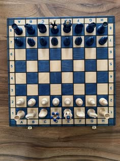 a blue and white checker board with several pieces on it