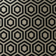 a black and white rug with hexagonal shapes on it's surface,