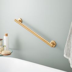 a bathroom with a towel rack and soap dispenser