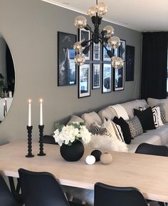 a living room filled with furniture and a large mirror on the wall next to a table