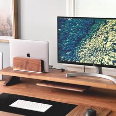 an apple computer sitting on top of a wooden desk