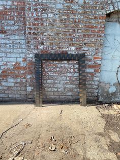 an old brick wall with a metal frame