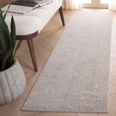 a large white rug in the middle of a living room