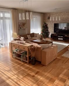 a living room filled with furniture and a flat screen tv on top of a wooden table