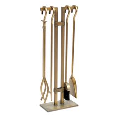 a gold metal fireplace tool holder