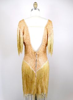 "This is an EXQUISITE heavily embellished vintage dress! It's completely hand beaded with glass beading and in excellent condition! Bust - 34-38\" Waist - 26-30\" Hips - 35-39\" Dress Length - 34\" / 38\" to the bottom of the fringe This dress comes from a pet-free and smoke-free home. If you would like more info or have any questions, please don't hesitate to ask!" Fitted Beaded Fringe Flapper Dress For Summer, Elegant Fitted Flapper Dress With Rhinestone Fringe, Elegant Sequin Ballroom Dresses, Glamorous Fitted Flapper Evening Dress, Glamorous Fitted Dress For Ballroom, Vintage Silk Flapper Dress Fitted, Vintage Silk Fitted Flapper Dress, Fitted Flapper Dress With Rhinestone Fringe For Cocktail, Fitted Beaded Fringe Flapper Dress For Gala