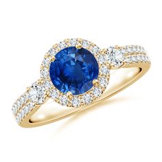 an oval blue sapphire and diamond ring with two side stones in yellow gold plated silver