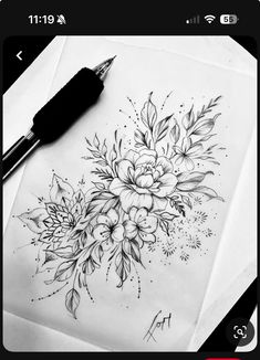 a pencil drawing of flowers and leaves on paper with a pen next to it,