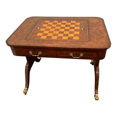 a wooden chess table with two drawers on one side and a checker board on the other