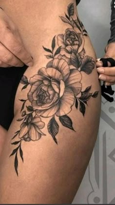 a woman's thigh with flowers on it