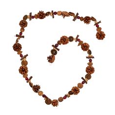 a heart made out of pine cones and beads