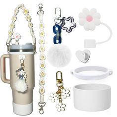 the contents of a travel mug are shown with key chains, bracelets, and other accessories