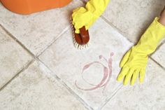 a person in yellow gloves and rubber gloves on the floor