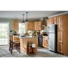 a kitchen filled with lots of wooden cabinets and counter top space next to a refrigerator