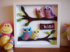 an owl and other stuffed animals are sitting in front of a shadow box with the word choo on it