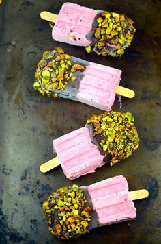 three popsicles with different toppings on them