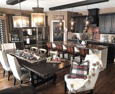 a living room filled with furniture and a dining table in front of a kitchen island