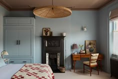 a bedroom with blue walls and furniture in it