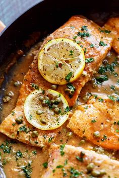 salmon with capers and lemons in a skillet