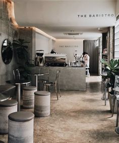 the interior of a restaurant with tables and stools