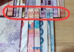 there is a red circle in the middle of many different bank notes that are on top of each other