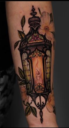 a lantern with flowers on the arm