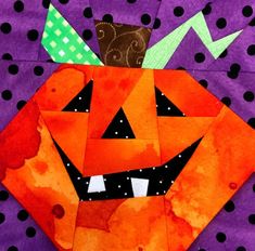 an orange pumpkin with a green hat on it's head sitting on a purple background