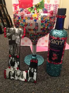 a wine glass and some personalized items sitting on the floor in front of a gift basket