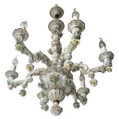 an ornate chandelier is shown against a white background with flowers and leaves on it