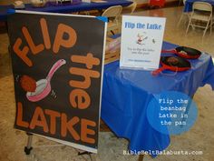 a sign that says flip the lake next to a blue table with some other items on it