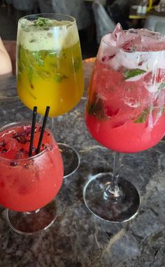 three different types of drinks on a table