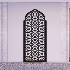 an ornate iron screen in the corner of a room with tile flooring and white walls